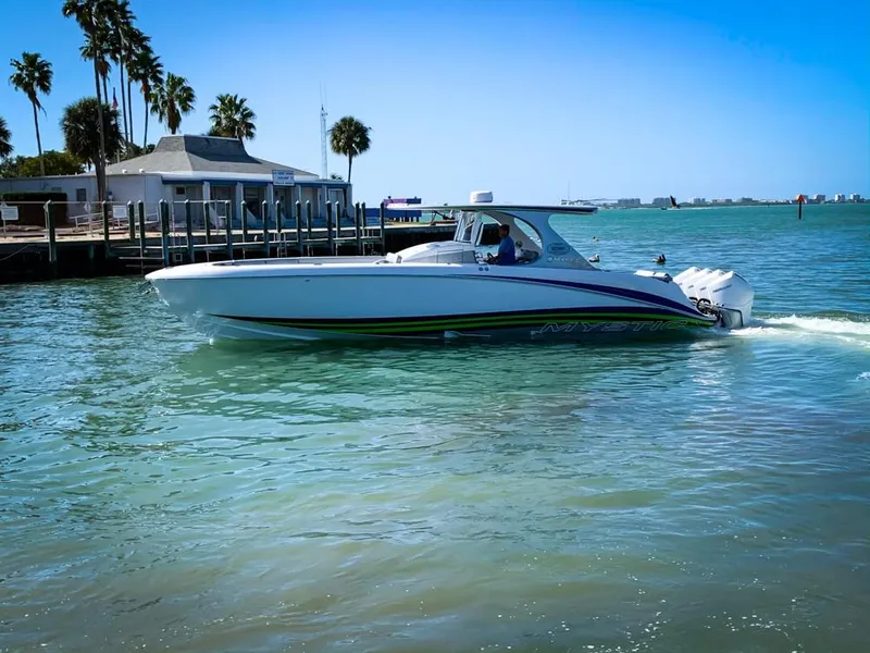 Slide: The Image of 2020 Mystic Powerboats M4200 cruising on a sunny day near a dock. - 59