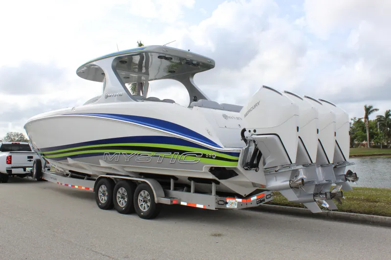 Slide: The Image of 2020 Mystic Powerboats M4200 on trailer with triple outboard engines. - 8