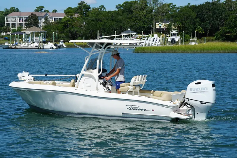 Slide: The Image of 2021 Pioneer 202 Islander boat on water, featuring Suzuki outboard motor, scenic background. - 6