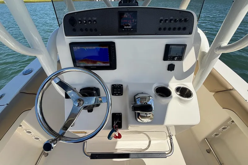 Slide: The Image of 2021 Pioneer 202 Islander boat dashboard with steering wheel, controls, and navigation screens. - 8