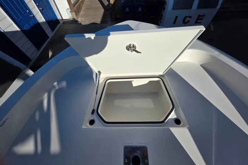 Slide: The Image of Open storage compartment on 2026 Ranger 2360 Bay boat, showcasing interior space. - 12