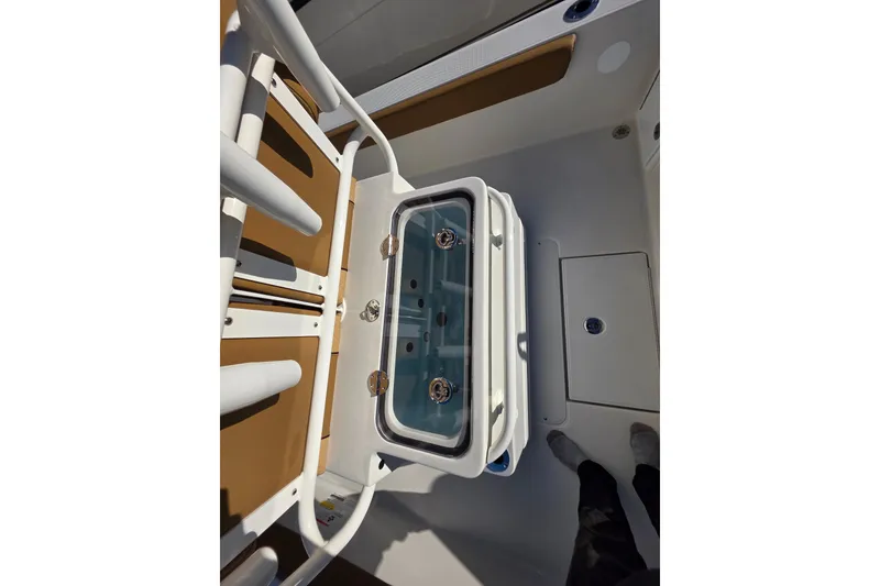 Slide: The Image of 2026 Ranger 2360 Bay boat interior with livewell and rod holders. - 18