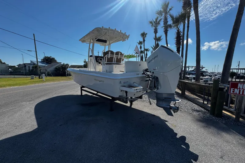 Slide: The Image of 2026 Ranger 2360 Bay boat with Mercury engine, parked near palm trees and marina. - 2