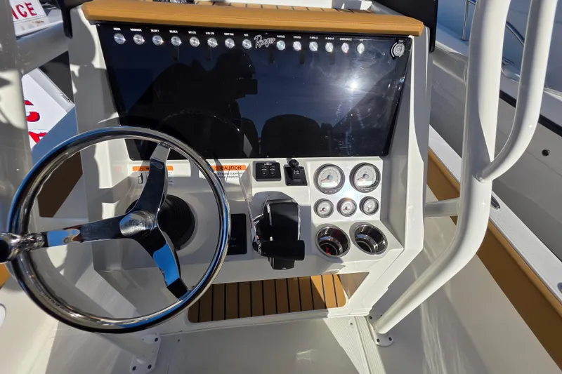 Slide: The Image of 2026 Ranger 2360 Bay boat dashboard with steering wheel and control panel. - 21