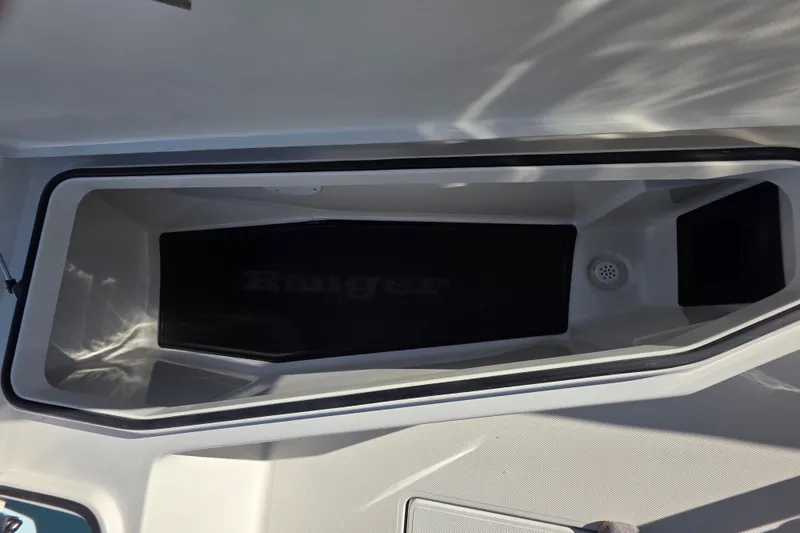 Slide: The Image of Open storage compartment in 2026 Ranger 2360 Bay boat, featuring sleek design and ample space. - 25