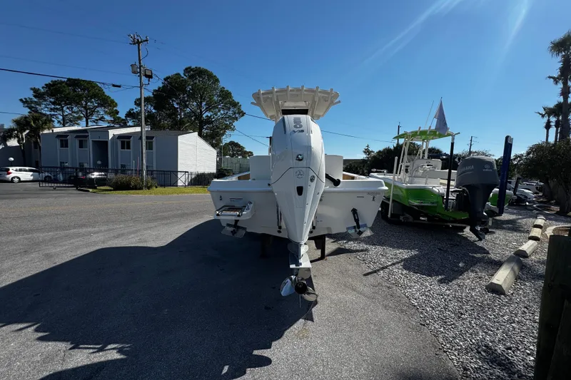 Slide: The Image of 2026 Ranger 2360 Bay boat displayed outdoors with palm trees and blue sky. - 3