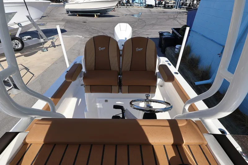 Slide: The Image of 2026 Ranger 2360 Bay boat interior with tan seating and steering wheel. - 33