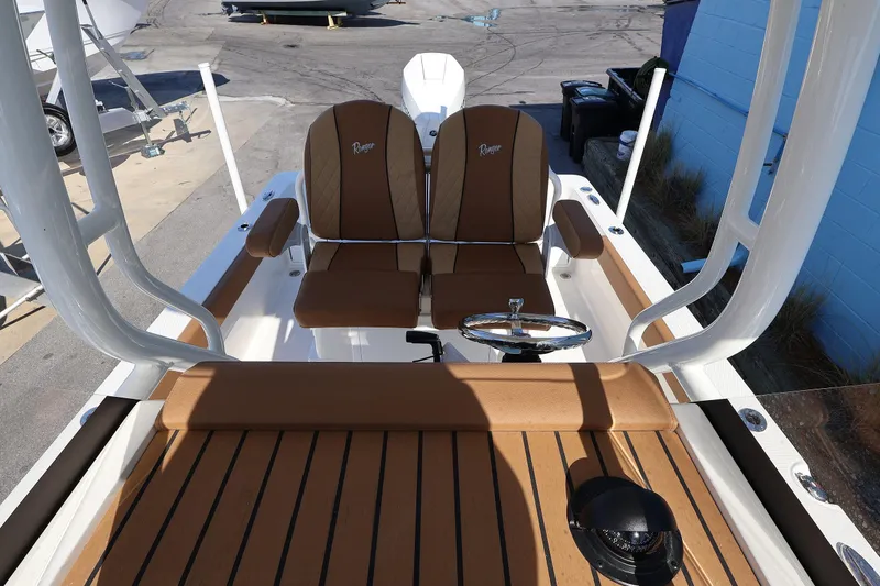 Slide: The Image of 2026 Ranger 2360 Bay boat interior with tan seating and steering wheel. - 34