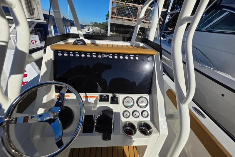 Slide: The Image of 2026 Ranger 2360 Bay boat dashboard with steering wheel and control panel. - 35