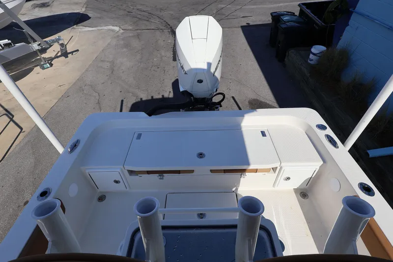 Slide: The Image of 2026 Ranger 2360 Bay boat deck with storage compartments and outboard motor. - 37