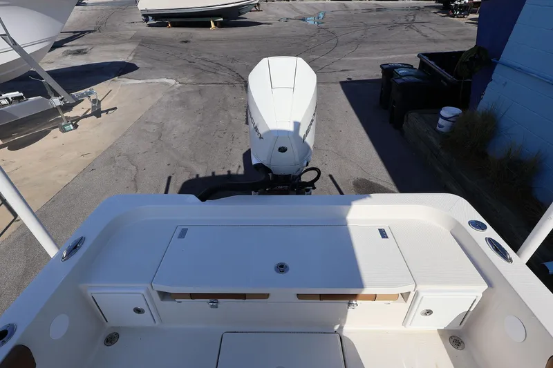 Slide: The Image of Ranger 2360 Bay 2026 boat with outboard motor, docked on a sunny day. - 38
