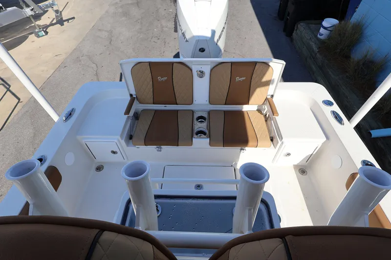 Slide: The Image of 2026 Ranger 2360 Bay boat interior with tan seating and rod holders. - 39