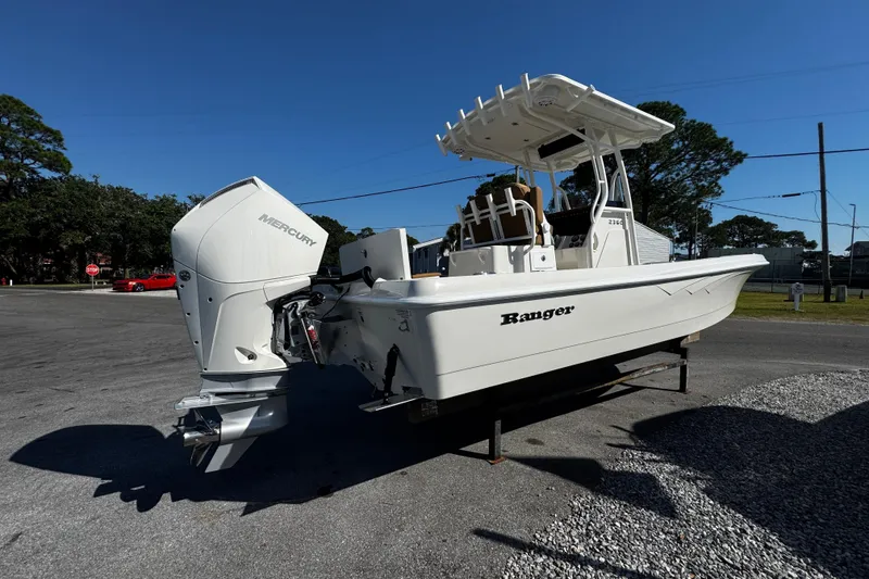 Slide: The Image of 2026 Ranger 2360 Bay boat parked outdoors on a sunny day. - 4