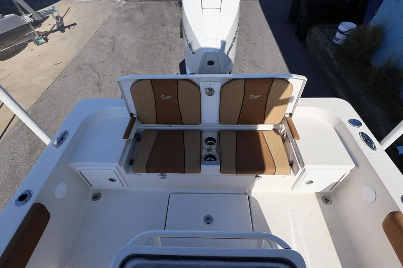 Slide: The Image of 2026 Ranger 2360 Bay boat interior with tan seating and cup holders. - 40