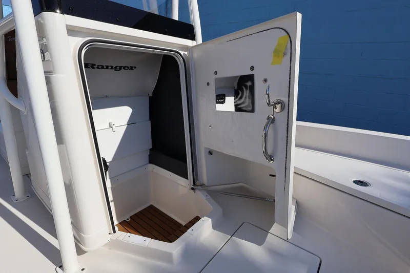 Slide: The Image of 2026 Ranger 2360 Bay boat interior storage compartment with open door. - 42