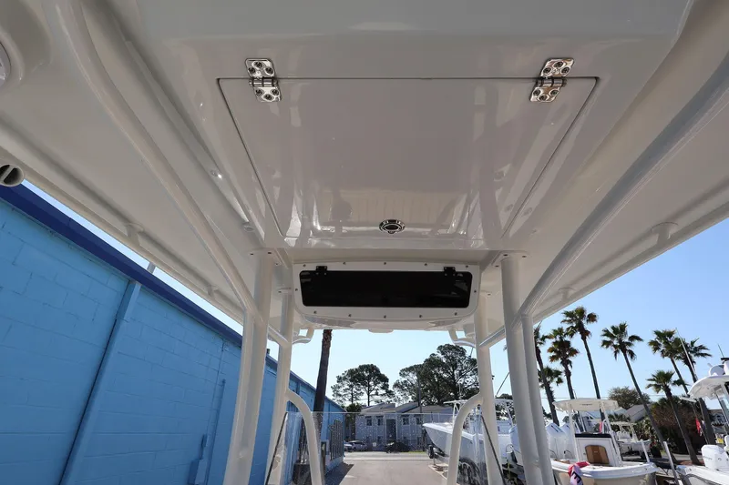 Slide: The Image of 2026 Ranger 2360 Bay boat interior view with storage compartment and blue wall background. - 43