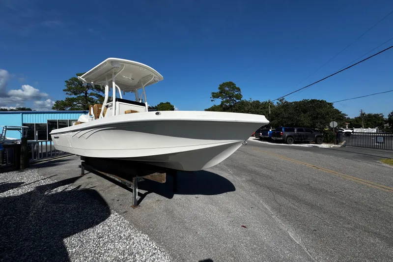 Slide: The Image of 2026 Ranger 2360 Bay boat displayed outdoors on a sunny day. - 6