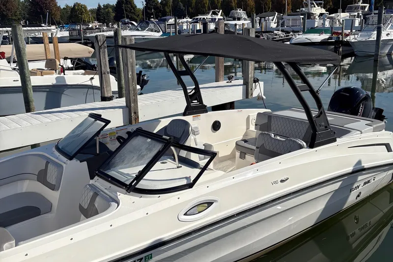 The Image of 2024 Bayliner VR6 Bowrider OB docked at a marina, featuring sleek design and spacious seating. - 1