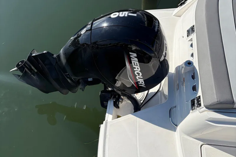 Slide: The Image of 2024 Bayliner VR6 Bowrider OB with Mercury outboard motor on calm water. - 4