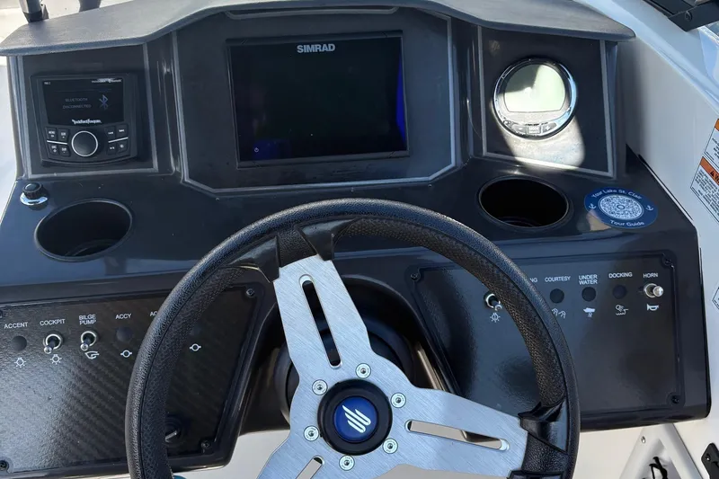 Slide: The Image of 2024 Bayliner VR6 Bowrider OB dashboard with steering wheel, controls, and Simrad display. - 6