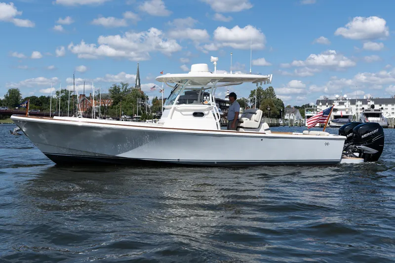 The Image of 2019 Hunt Yachts 32CC boat cruising on a sunny day with American flag. - 1