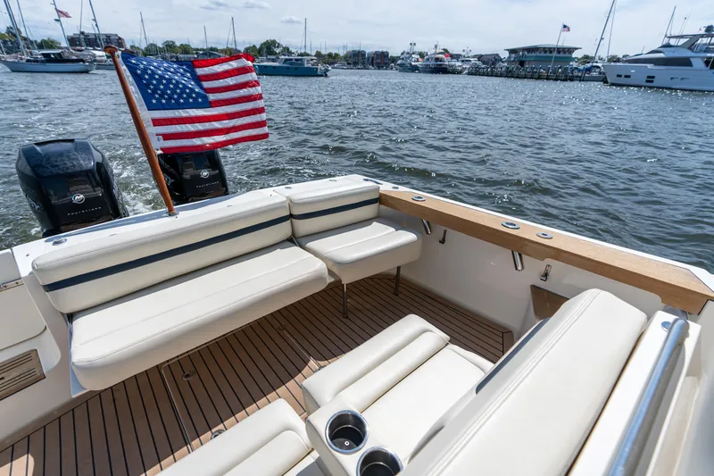Slide: The Image of 2019 Hunt Yachts 32CC boat interior with American flag, docked in a marina. - 10