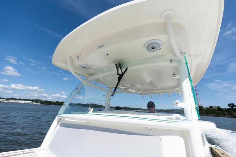 Slide: The Image of 2019 Hunt Yachts 32CC on water, featuring sleek design and modern canopy. - 13