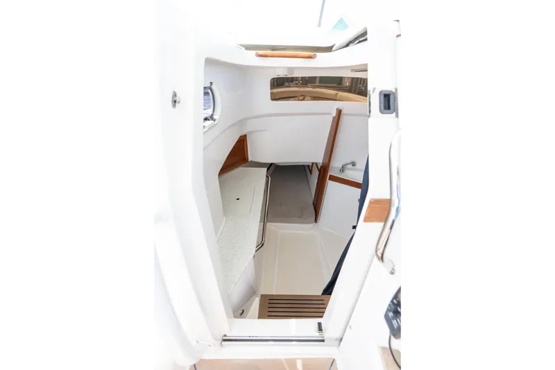 Slide: The Image of 2019 Hunt Yachts 32CC cabin interior with white and wood accents. - 23
