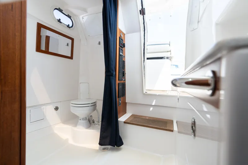 Slide: The Image of 2019 Hunt Yachts 32CC interior with toilet, mirror, and wooden accents. - 26