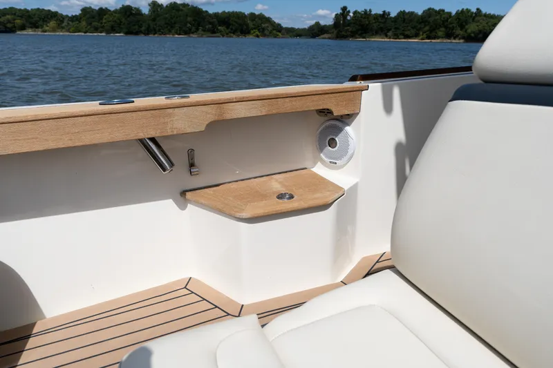 Slide: The Image of 2019 Hunt Yachts 32CC interior detail with wood accents and speaker, overlooking serene water. - 28