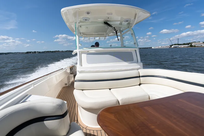 Slide: The Image of 2019 Hunt Yachts 32CC cruising on open water, featuring luxurious seating and sleek design. - 12
