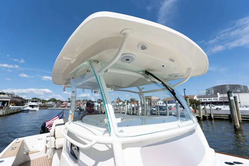 Slide: The Image of 2019 Hunt Yachts 32CC boat docked at marina under clear blue sky. - 14