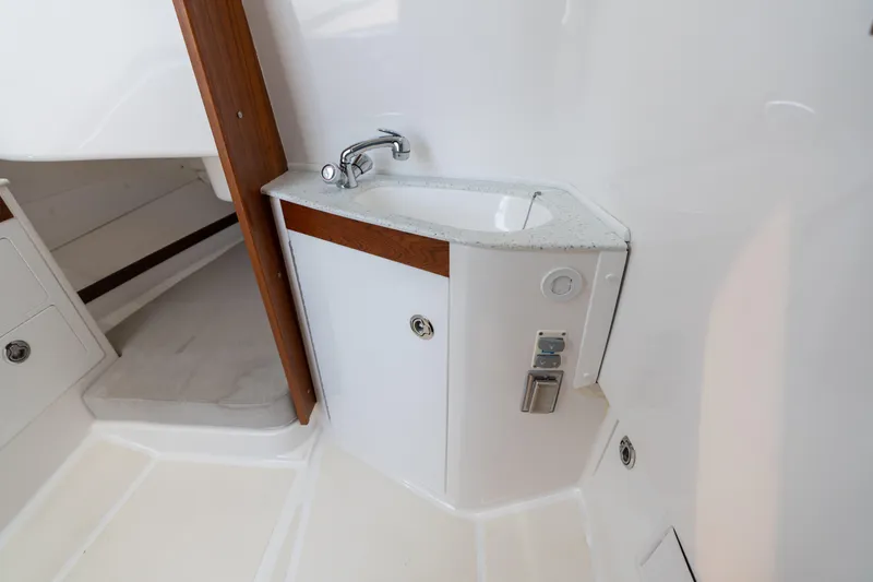 Slide: The Image of 2019 Hunt Yachts 32CC interior with compact sink and wooden accents. - 25