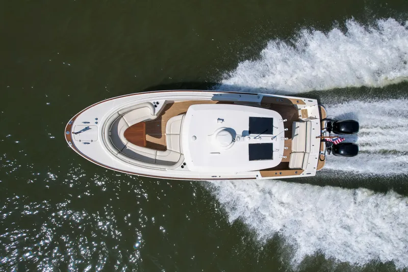 Slide: The Image of Aerial view of 2019 Hunt Yachts 32CC cruising on water, showcasing sleek design and powerful engines. - 39