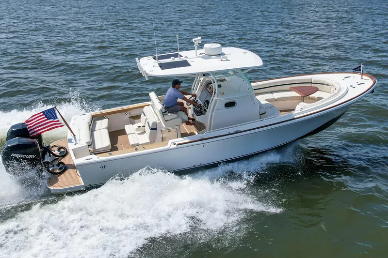 Slide: The Image of 2019 Hunt Yachts 32CC cruising on open water with American flag. - 40