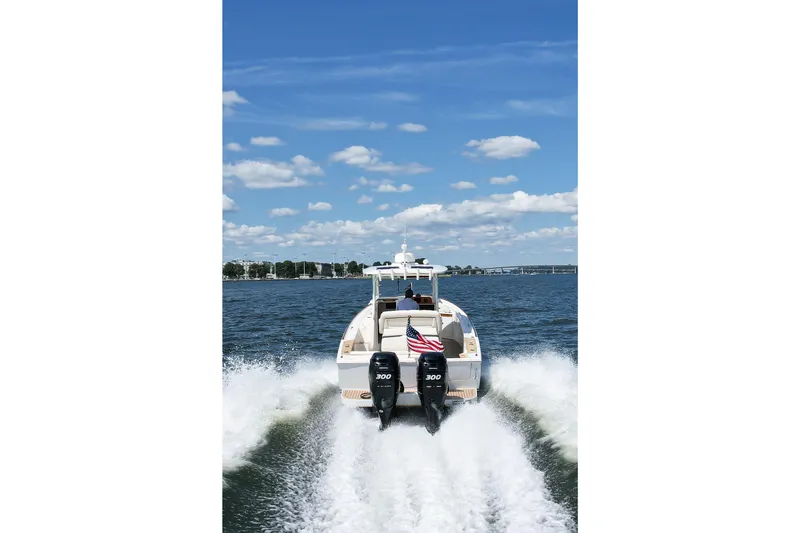 Slide: The Image of 2019 Hunt Yachts 32CC cruising on open water under a clear blue sky. - 41