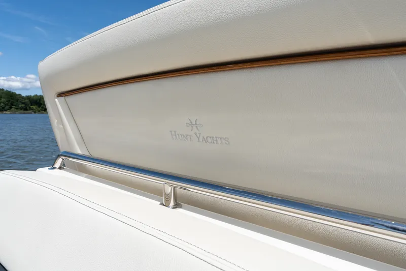 Slide: The Image of 2019 Hunt Yachts 32CC boat interior with logo, featuring elegant white upholstery. - 42