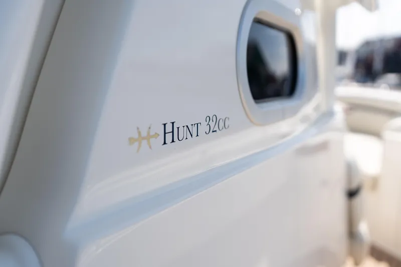 Slide: The Image of 2019 Hunt Yachts 32CC boat exterior with logo and window detail. - 44