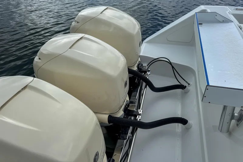 Slide: The Image of Three outboard motors on a 2009 Jupiter 39 Express boat. - 13