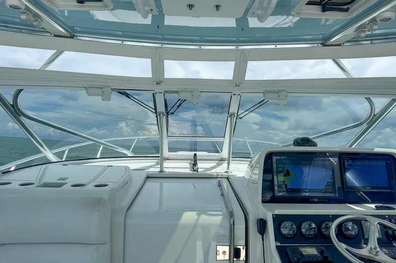 Slide: The Image of 2009 Jupiter 39 Express boat cockpit with navigation screens and ocean view. - 14