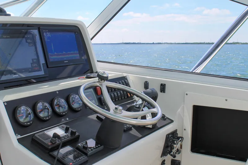 Slide: The Image of Helm of 2009 Jupiter 39 Express boat with navigation screens and ocean view. - 16