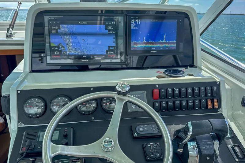 Slide: The Image of 2009 Jupiter 39 Express helm with navigation screens and control panel. - 17
