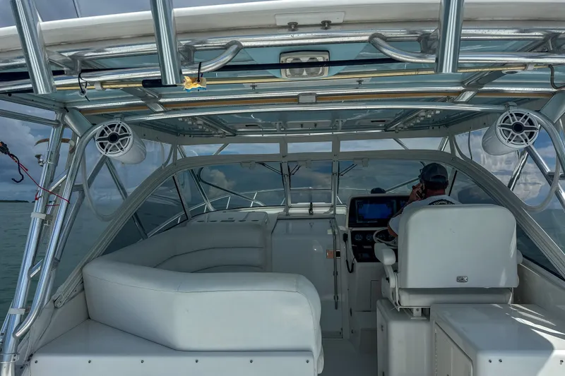 Slide: The Image of 2009 Jupiter 39 Express boat interior with white seating and modern controls. - 19