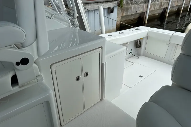 Slide: The Image of 2009 Jupiter 39 Express boat interior with white seating and storage compartments. - 20