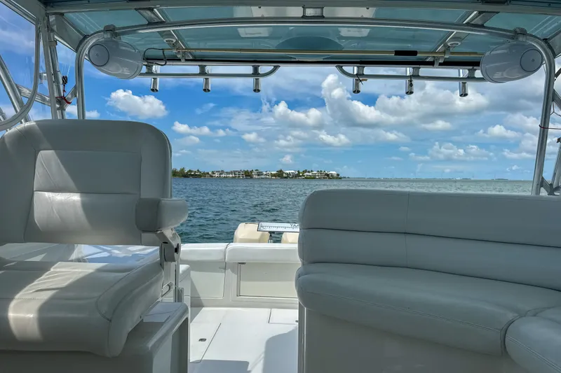 Slide: The Image of 2009 Jupiter 39 Express boat interior with ocean view, featuring white seating and clear skies. - 22