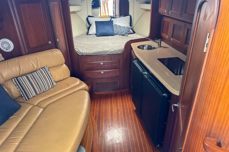 Slide: The Image of Luxurious interior of 2009 Jupiter 39 Express yacht with cozy seating and compact kitchen. - 23