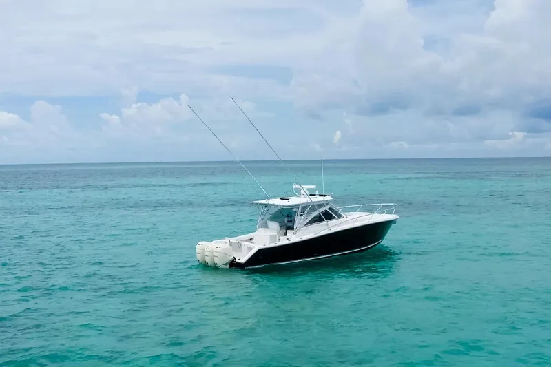 Slide: The Image of 2009 Jupiter 39 Express boat cruising on calm ocean waters under a cloudy sky. - 3