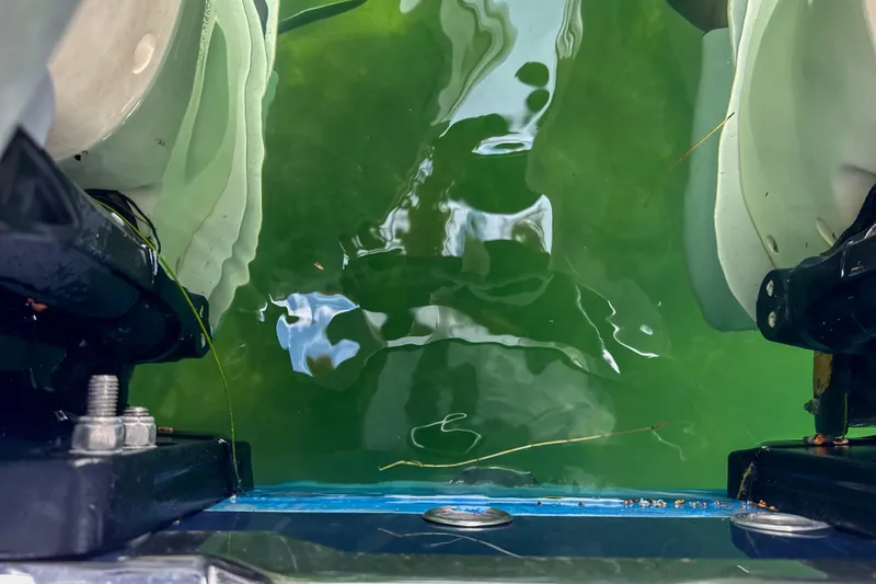 Slide: The Image of Close-up of 2009 Jupiter 39 Express boat engine area with green water reflection. - 32