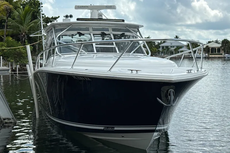 Slide: The Image of 2009 Jupiter 39 Express boat docked on calm water, surrounded by tropical scenery. - 6