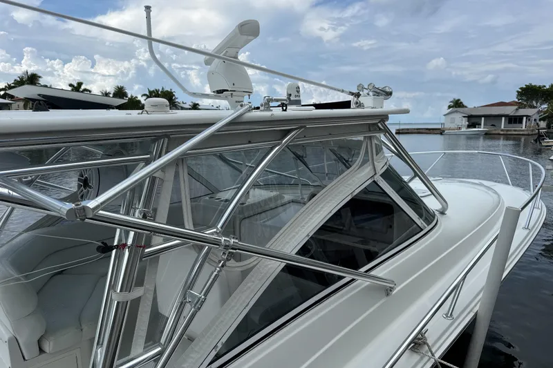 Slide: The Image of 2009 Jupiter 39 Express boat docked by waterfront homes under a cloudy sky. - 7